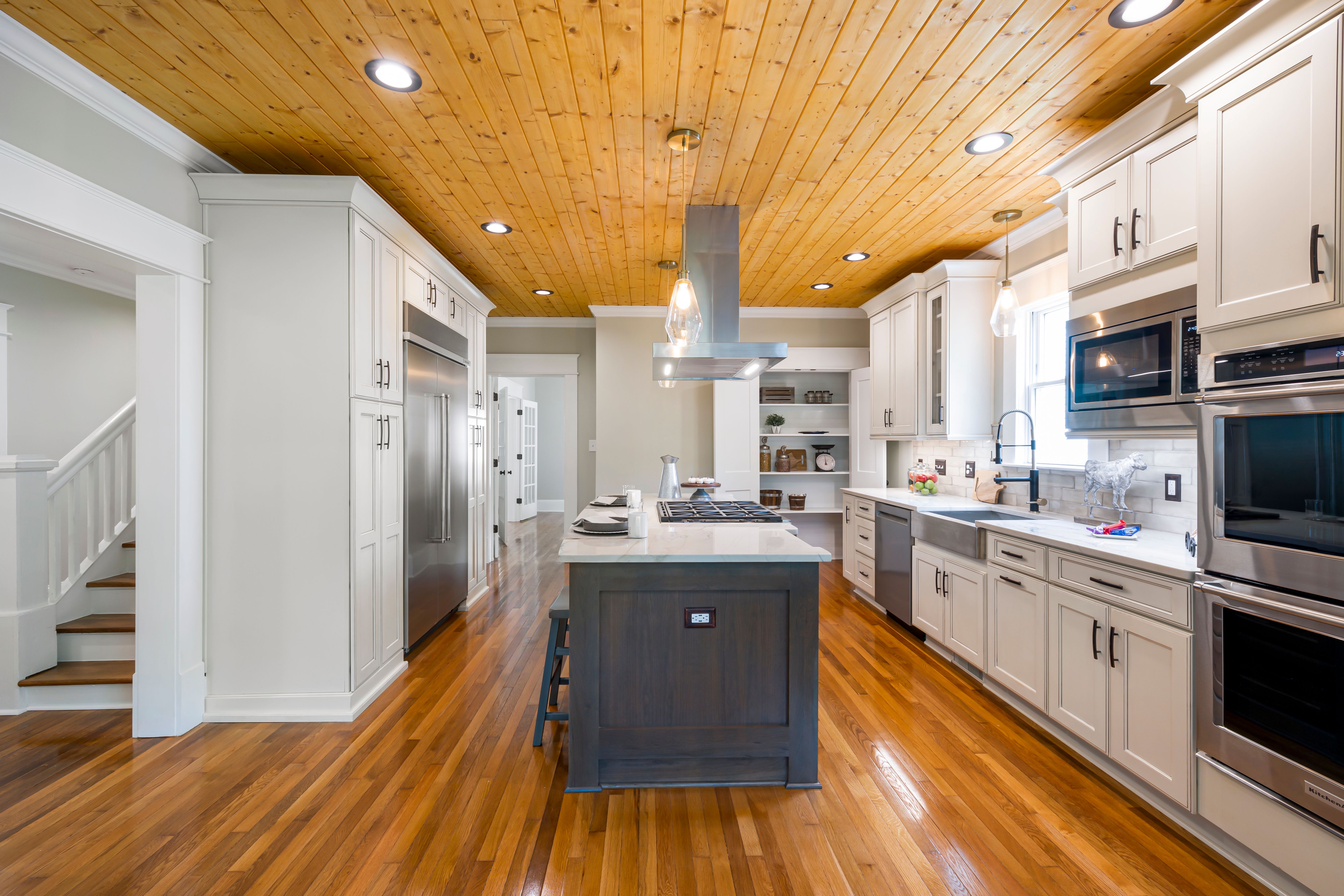 Warm modern kitchen remodel with island and brass fixtures