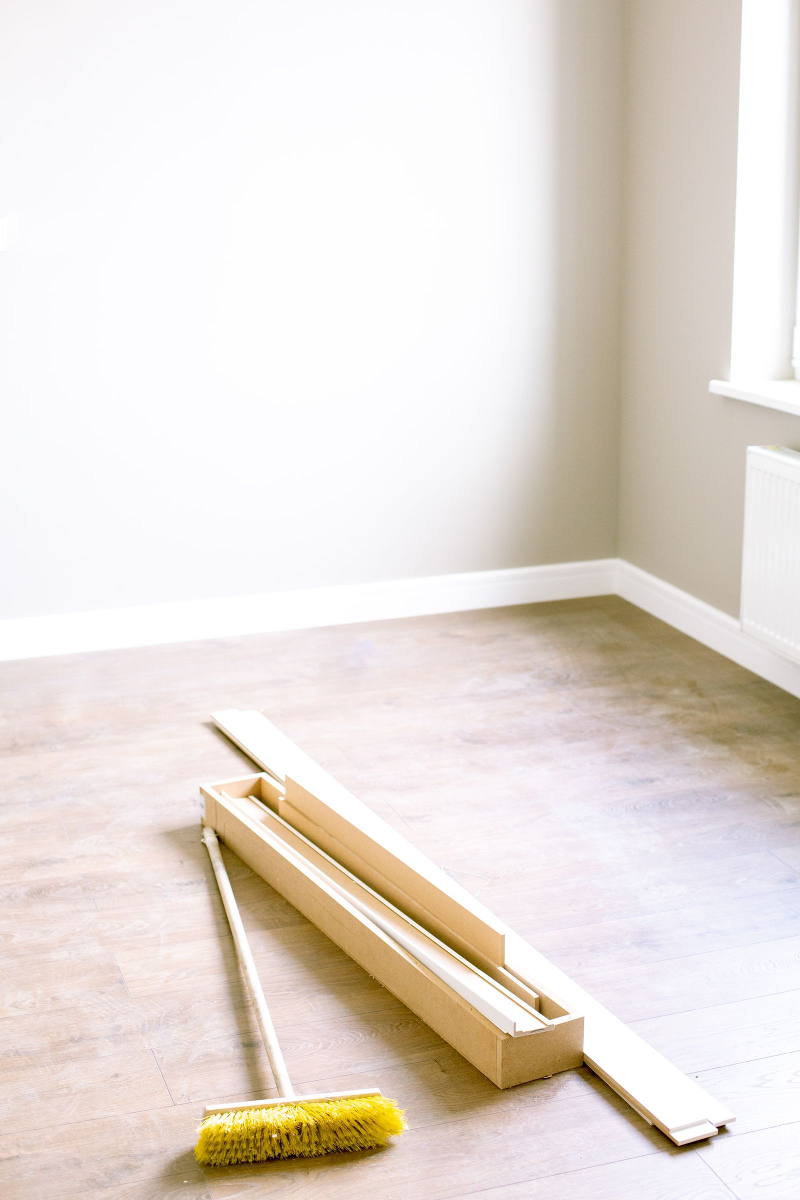 Room prepped for flooring installation with planks laid out