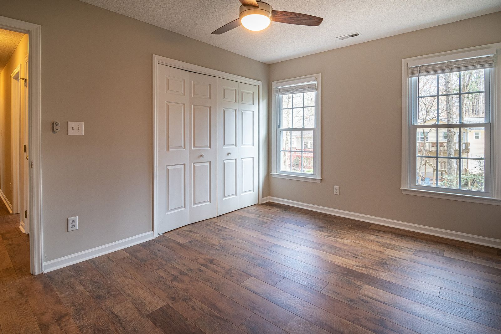 Spacious room with new hardwood flooring and natural light
